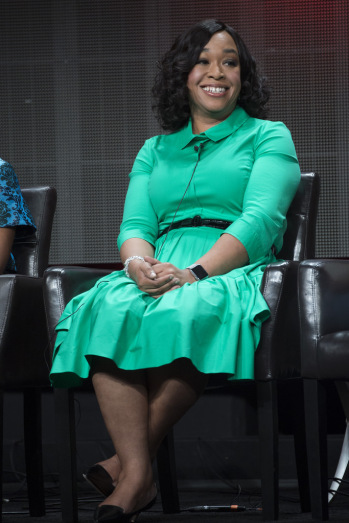 Shonda Rhimes smiling while sat on chair on stage